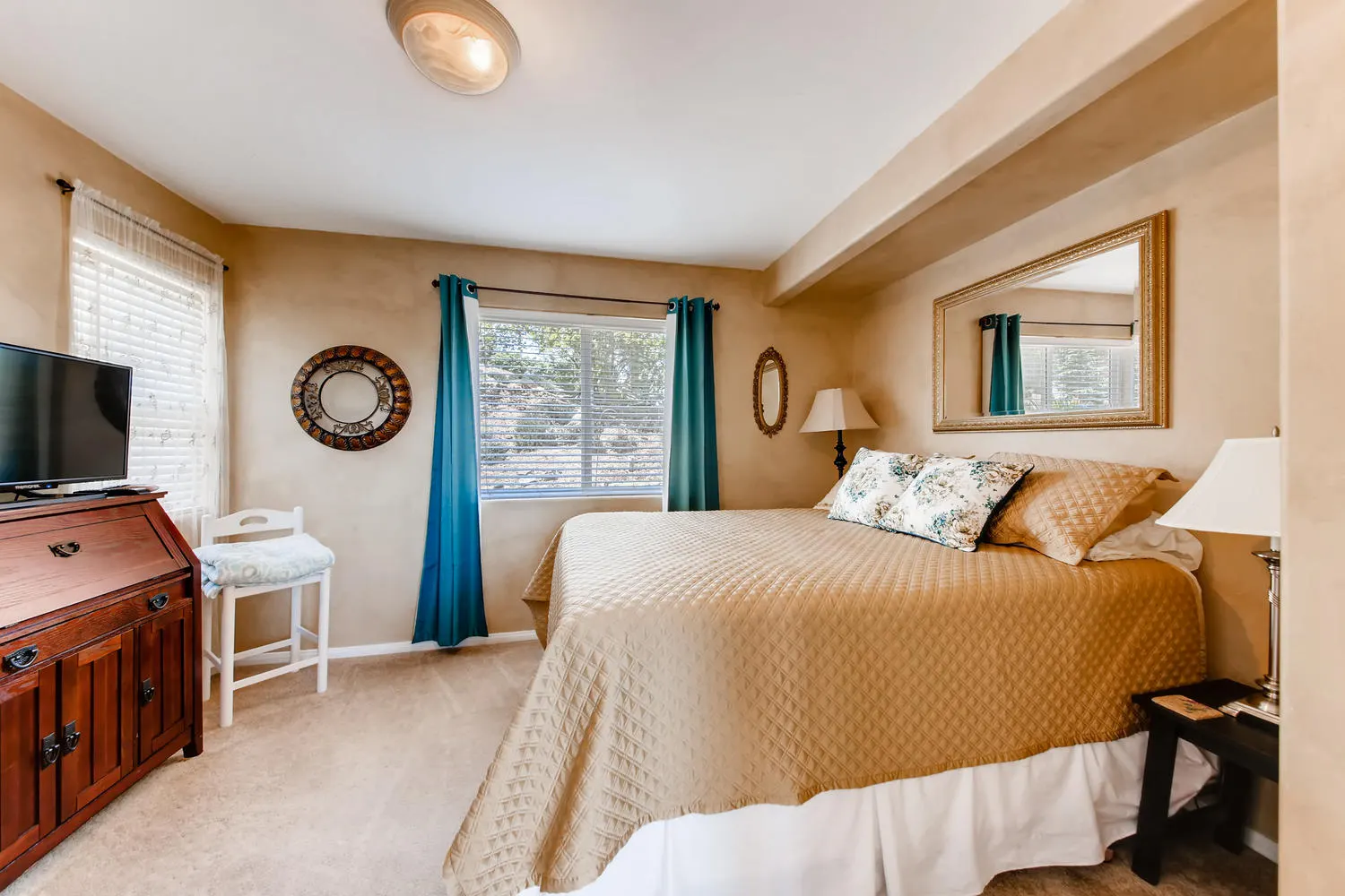 The Guest Suite with a queen bed, plush linens and a flat-screen television