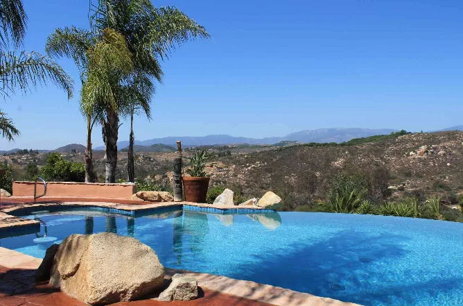 The infinity edge of the pool with the mountains beyond