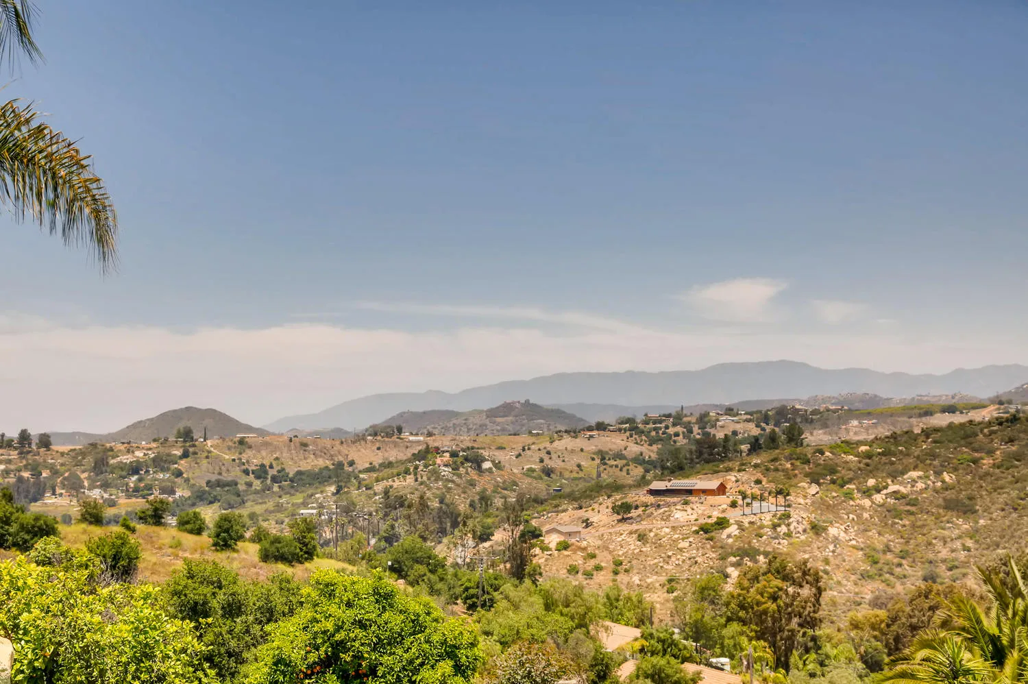The view from the estate over the orchard toward the valley and the mountains beyond